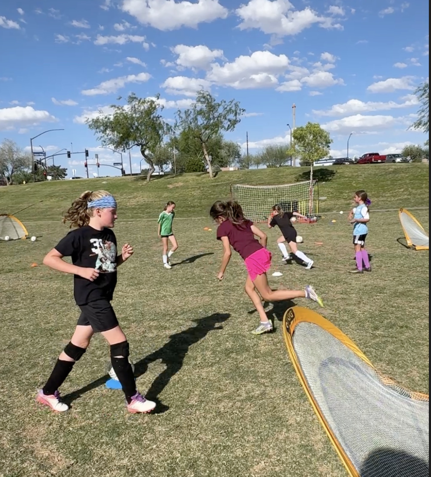 Young player going 1v1 toward a net during a training game.