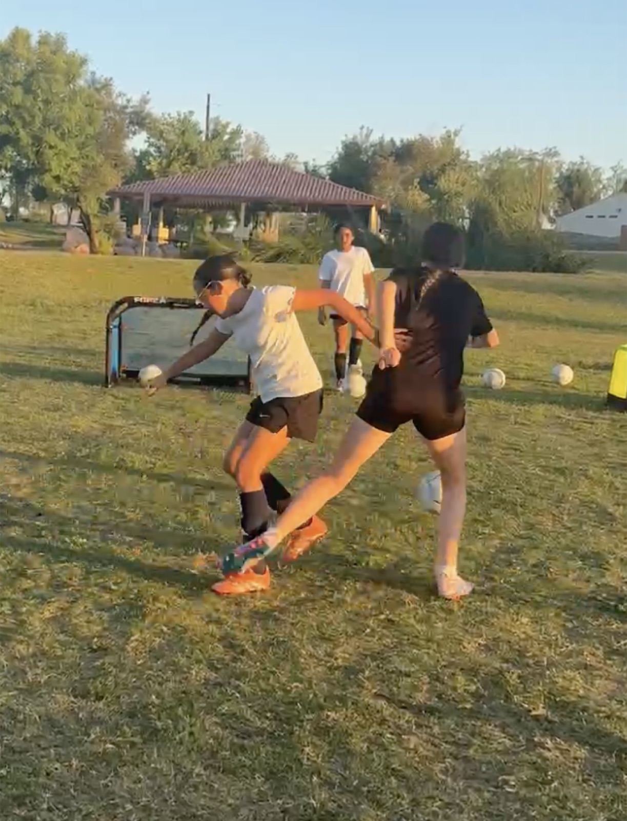 Two youth players competing in a 1v1 battle during training.