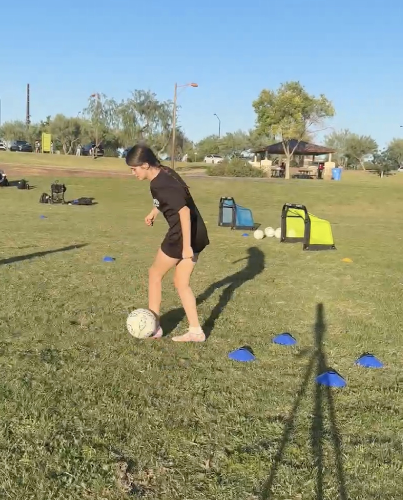 Young player shooting at mini-goals during a finishing drill.