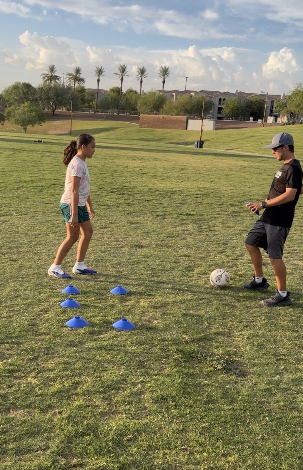 Young player working through a cone footwork drill with Coach David Fales.