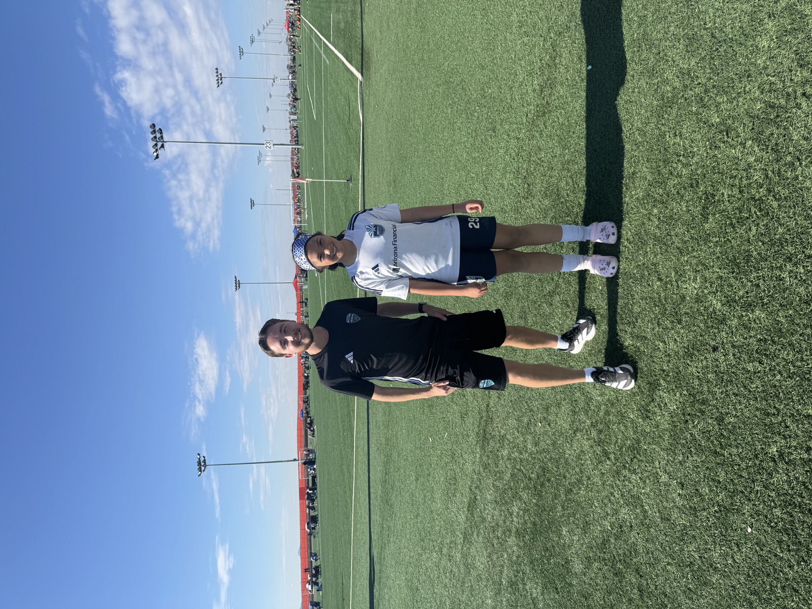Coach David Fales with a youth soccer player at a tournament complex on game day.