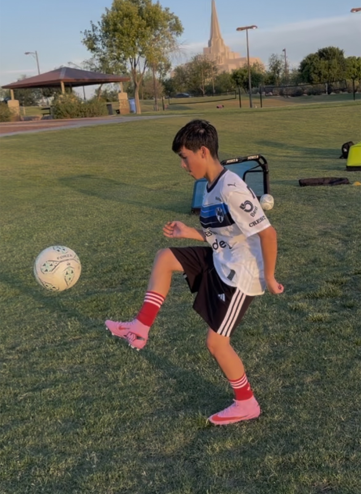 Youth player controlling a soccer ball with a first touch during training.